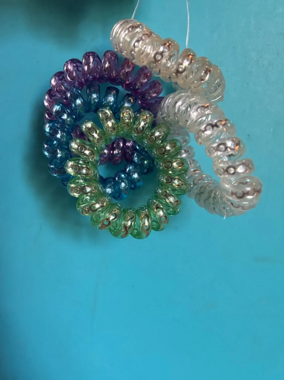 Set of 5 Coiled Hair Ties in Clear, Purple, Blue, Green
